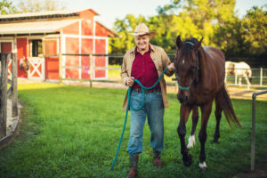 Farmer walking horse